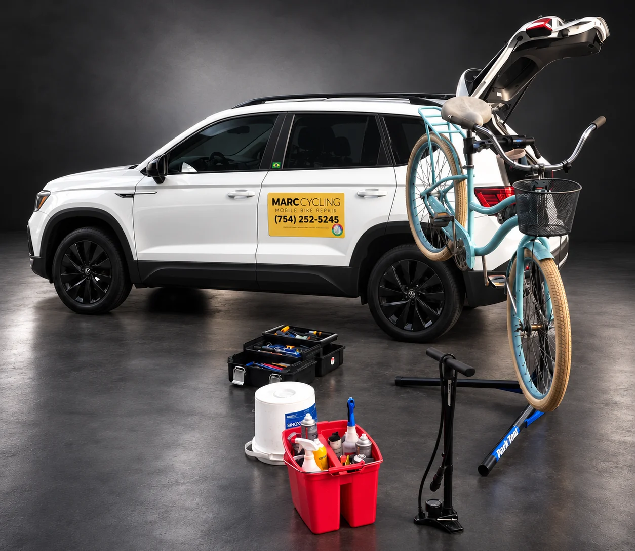 The Marc Cycling vehicle, a white VW Taos with the yellow Marc Cycling Mobile Bike Repair magnet and the phone number (754) 252-5245 on the door, tailgate open, a bike on the rack, and the Park Tool repair stand, floor pump and tool kits set out next to it.